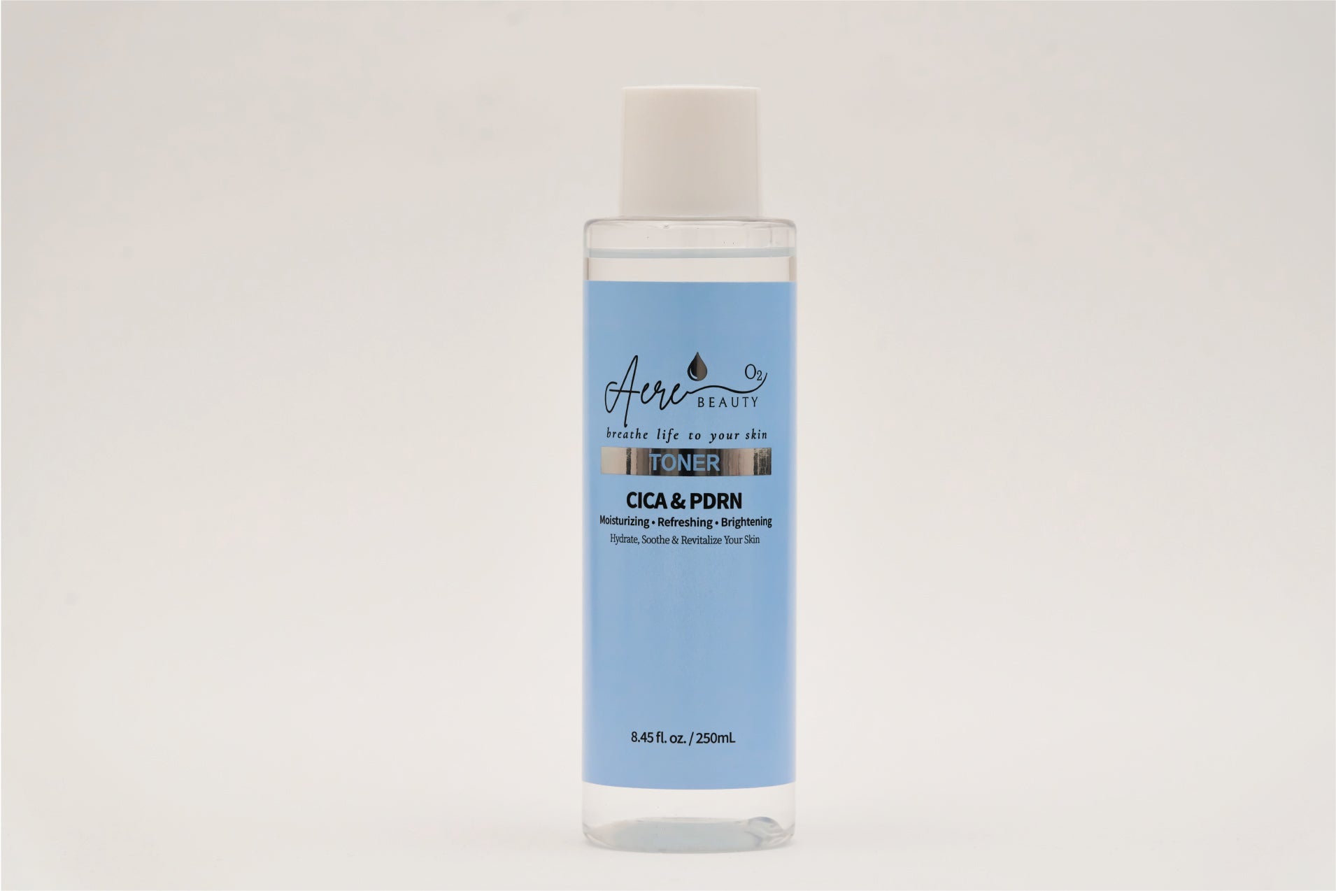 A bottle of Aere Beauty toner with a blue label on a white background