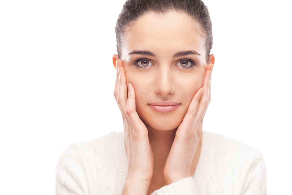Woman applying AERE Beauty K-beauty skincare for healthy glowing skin